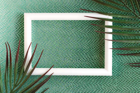 White photo frame on green background with crocodile pattern. minimal concept. Template for designの写真素材