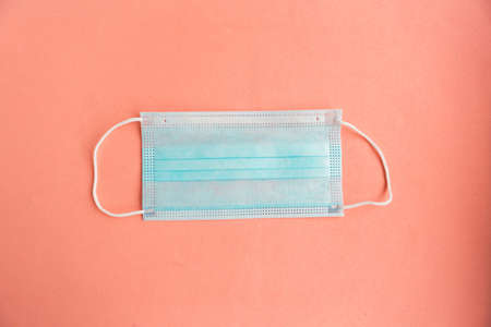 Face mask on pastel pink background. Top view, minimalの写真素材