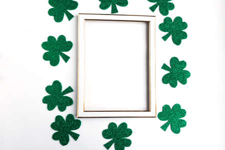 Green shamrock frame on white background. Three leaf clover, top view. minimal concept. Symbol of St. Patrick's Day. Copy space for the textの写真素材