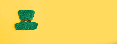 Saint Patrick leprechaun paper hat isolated on bright yellow background. minimal concept. Copy space for the textの写真素材