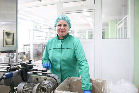 Minsk Belarus â€“ March 4 2021: Woman works at factory with a conveyer belt