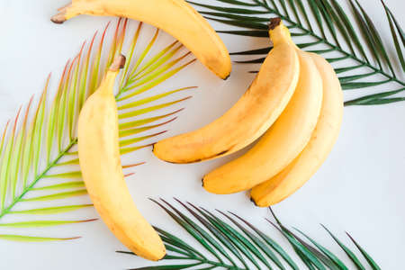 Fresh tasty yellow bananas on white background. Healthy food concept. Minimal conceptの写真素材