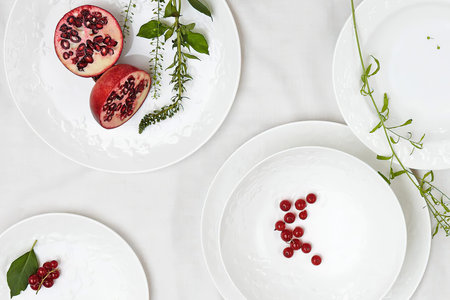 Delicious juicy sliced pomegranate on a plate, top view, flat lay