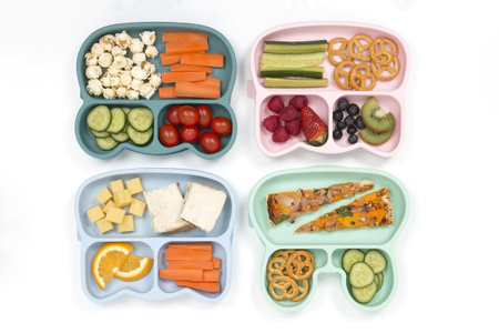 Color lunch boxes with different types of foodの写真素材
