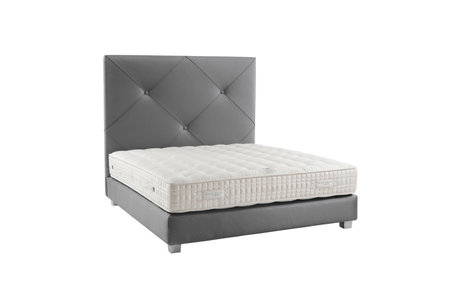 Modern bed with blanket and pillows isolated on whiteの写真素材
