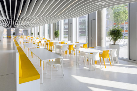 Hamburg, Germany - October 29 2020: Empty modern cafe interior in yellow and white colors,...