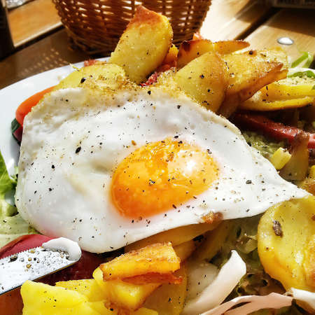 Fries potatoes with fried eggの写真素材