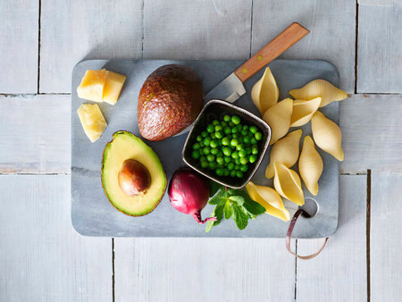 Ingredients of pasta with avocado sauce, peas and parmesan