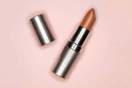 Red lipstick on pink background, top view. Minimal conceptの写真素材