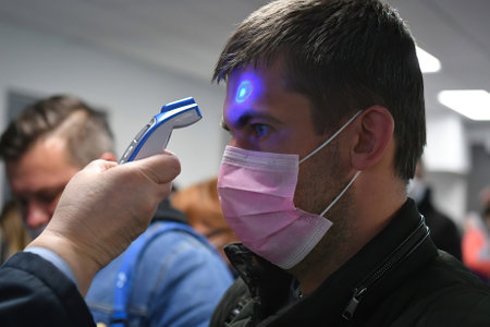 Minsk Belarus â March 22 2020: measurement of body temperature for passengers during the coronavirus outbreakのeditorial素材