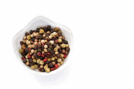mixed pepper in bowl, white background, copy spaceの写真素材
