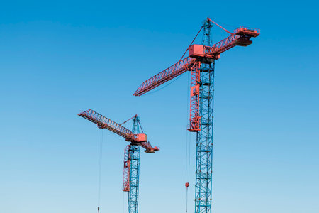 construction cranes against blue sky