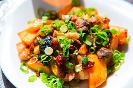 fried meat and potatoes on a plateの写真素材