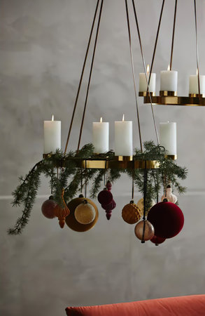 chandelier with candles and Christmas decorations in home interiorの写真素材