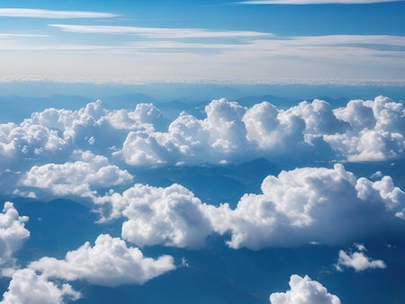 Aerial view of clouds in the blue sky. View from airplane window.の素材
