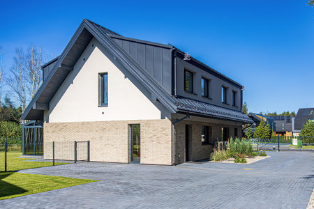 Modern house with a roof from a bituminous tile and a concrete floorの写真素材