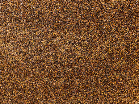 Abstract background with small stone chips, grainy texture. A simple pattern of small stones, sand. Detailed image of sand, stone plaster.の写真素材