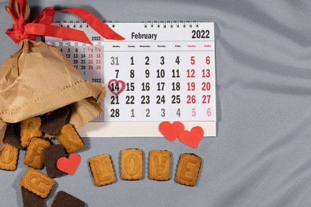 Valentines day background.Valentines day greeting card.Package with cookies,calendar,hearts,top...
