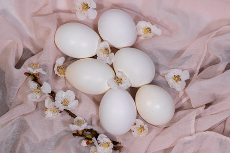 Happy Easter. Easter eggs on a delicate pink background with flowers.Minimalistic style,top...