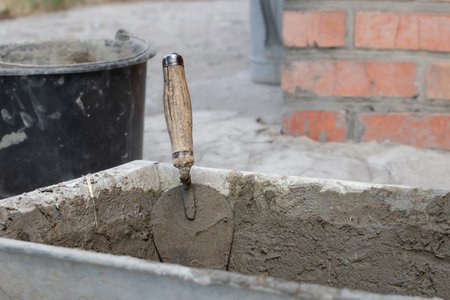 A metal trowel with a wooden handle.の写真素材