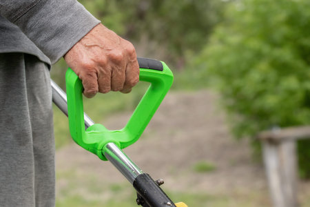 Electric grass trimmer.Professional gardening tool on lawn grass.Lawn care in backyard.