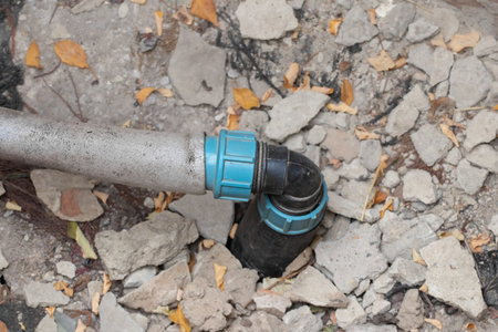 Plastic pipe for water supply from hole.Pumping water into the house.の写真素材