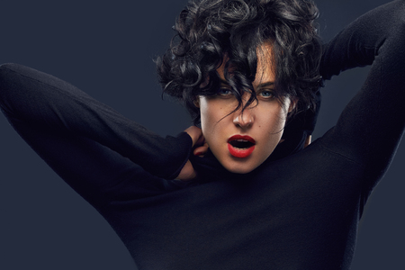 Studio portrait of a young beautiful fashionable woman wearing stylish closes. Female fashion, beauty and advertisement concept. Close up. Copy space for textの写真素材