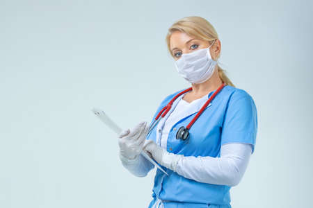 Smiling medical doctor woman with stethoscope. Isolated over white backgroundの写真素材