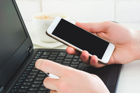Man using smartphone and credit card to make online payment. Mockup photo of lmobile phone with...