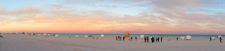 Miami Beach, United States - February 12, 2016: People walk and relax at the evening South Beach of Miami near Atlantic Ocean.のeditorial素材