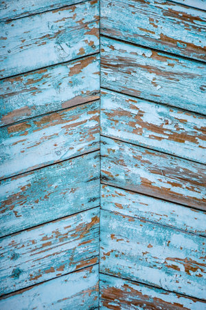 Background of an old blue painted wooden wall from boards, handmade, vertical, close-upの写真素材