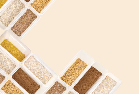 Various cereals - wheat, peas, buckwheat, millet, oatmeal, barley in open plastic containers , top view, copy-space, horizontalの写真素材