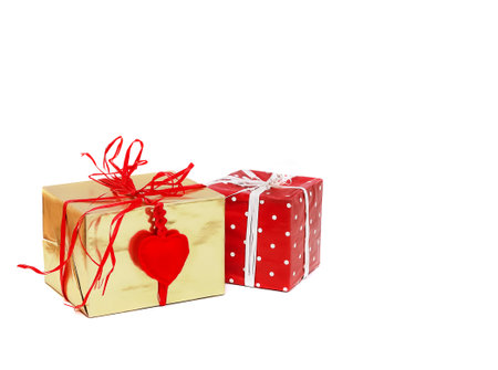 Two gift boxes in gold and red polka dot packaging with soft fabric heart isolated on white background, copy spaceの写真素材