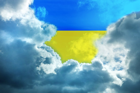 Frame of large storm clouds against the background of the yellow-blue sky of the colors of the Ukrainian flag, horizontally, copyspaceの写真素材