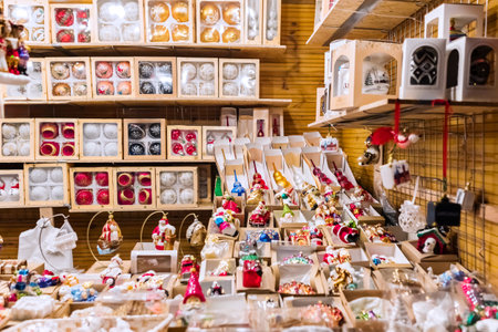 Various Christmas ornaments, including balls, stars, snowflakes, garlands, and lights, are showcased at a lively market stall, offering a wide selection of festive decor.の写真素材