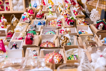 A dazzling array of Christmas ornaments, including balls, figurines, glass pieces, crafts, and artwork, on display at a joyful holiday market, spreading seasonal cheer.の写真素材