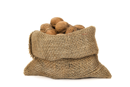 Walnuts in a bag on the white isolated backgroundの写真素材