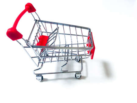 Small food cart. Sharing in a supermarket. Red iron trolley on wheelsの写真素材