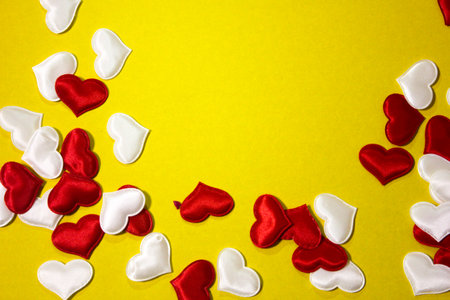Small red and white hearts that are scattered on a yellow background. Valentine's Day. Valentine's day, February 14.の写真素材