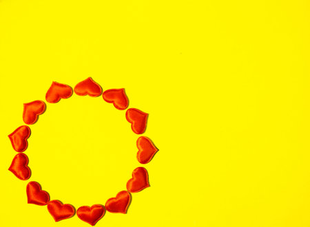 Red hearts folded in a circle on a yellow background. Valentines Day