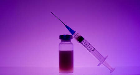 Medicine in a test tube on which lies a syringe.のeditorial素材