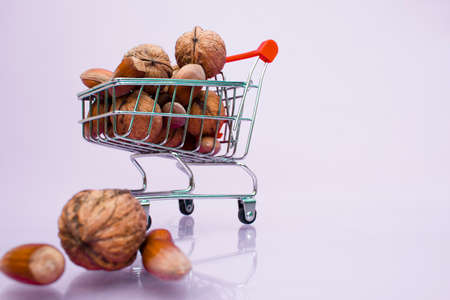 Walnut and hazelnuts in a supermarket cart.の写真素材
