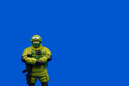 A military soldier. Green form, war in Ukraine, peace. Blue backgroundのeditorial素材