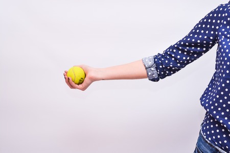 Tennis ball in hand girlの写真素材