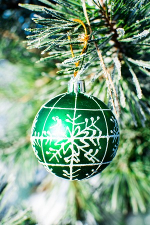 Close up of christmas decorations green ball at xmas tree outdoor.の写真素材