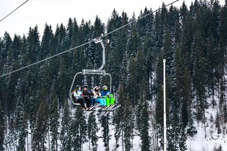 BUKOVEL, UKRAINE - December 17, 2016 : Skiers on a cable car in Bukovel. Bukovel is the most popular ski resort in Ukraine. Ski season and Winter sports conceptのeditorial素材