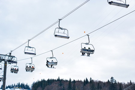 BUKOVEL, UKRAINE - December 17, 2016 : Skiers on a cable car in Bukovel. Bukovel is the most popular ski resort in Ukraine. Ski season and Winter sports conceptのeditorial素材