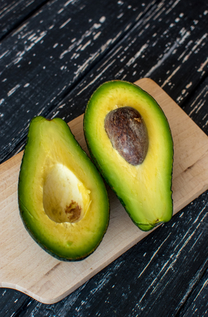 Two pies of avocado on wooden black table.の写真素材