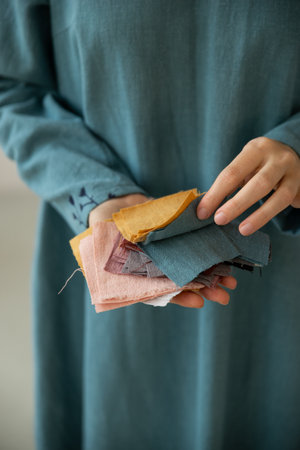 Female holding prices of colourful linen tissue examples.の写真素材