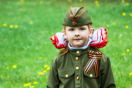 VOLGOGRAD, RUSSIA - MAY 9, 2010: A little girl in a military uniform on Victory Day celebration in Volgogradのeditorial素材